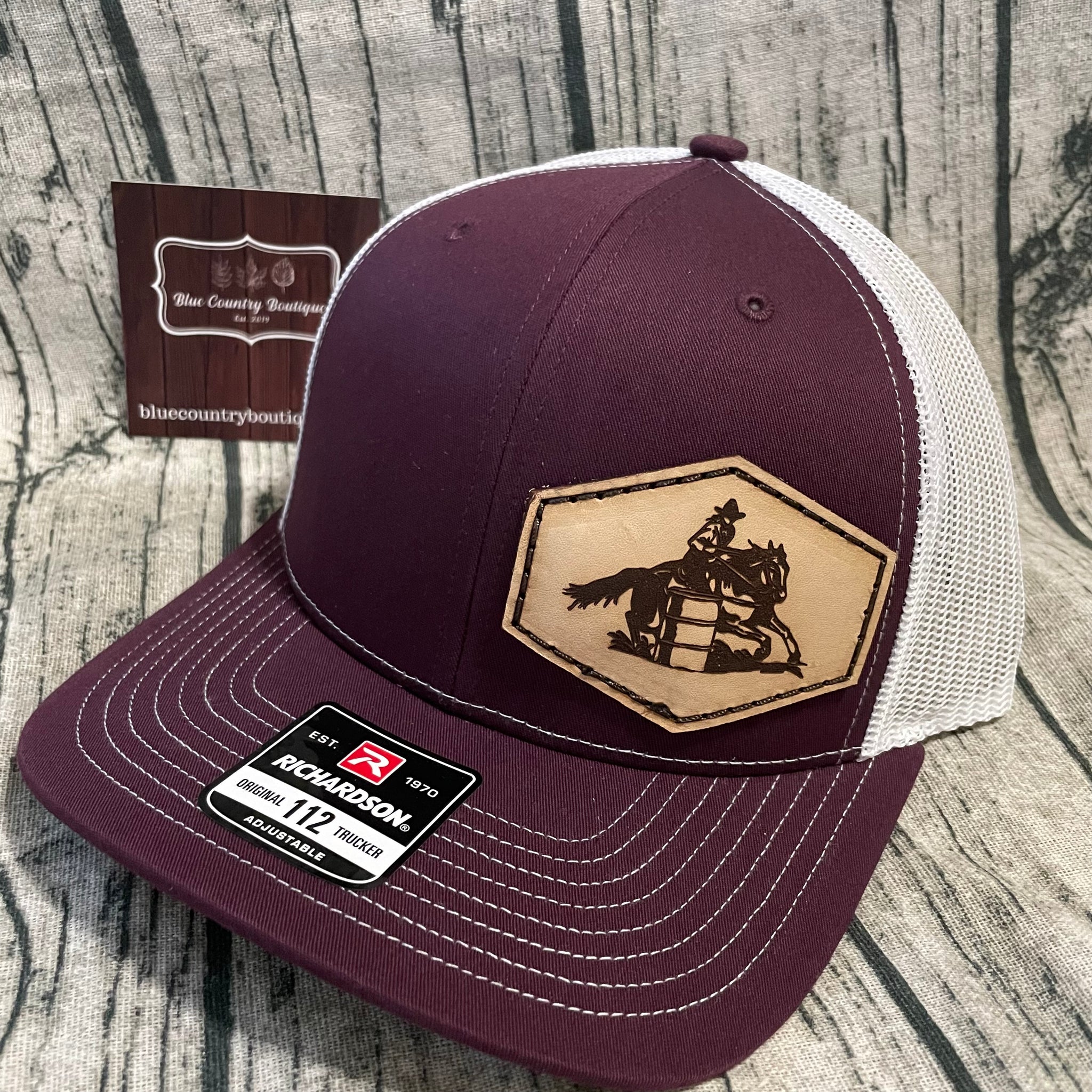 maroon/white custom barrel racing leather patch hat. 